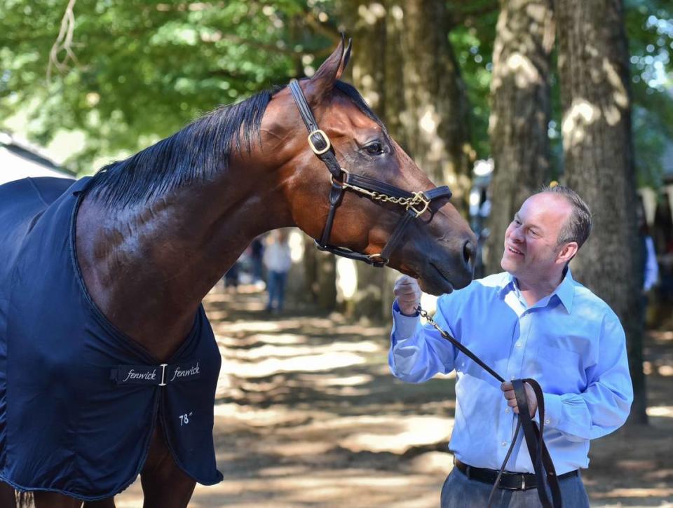 Horse racing announcer Larry Collmus is shown with American Pharoah, the horse who won the 2015 Triple Crown. Collmus has announced the Kentucky Derby for NBC Sports since 2011.