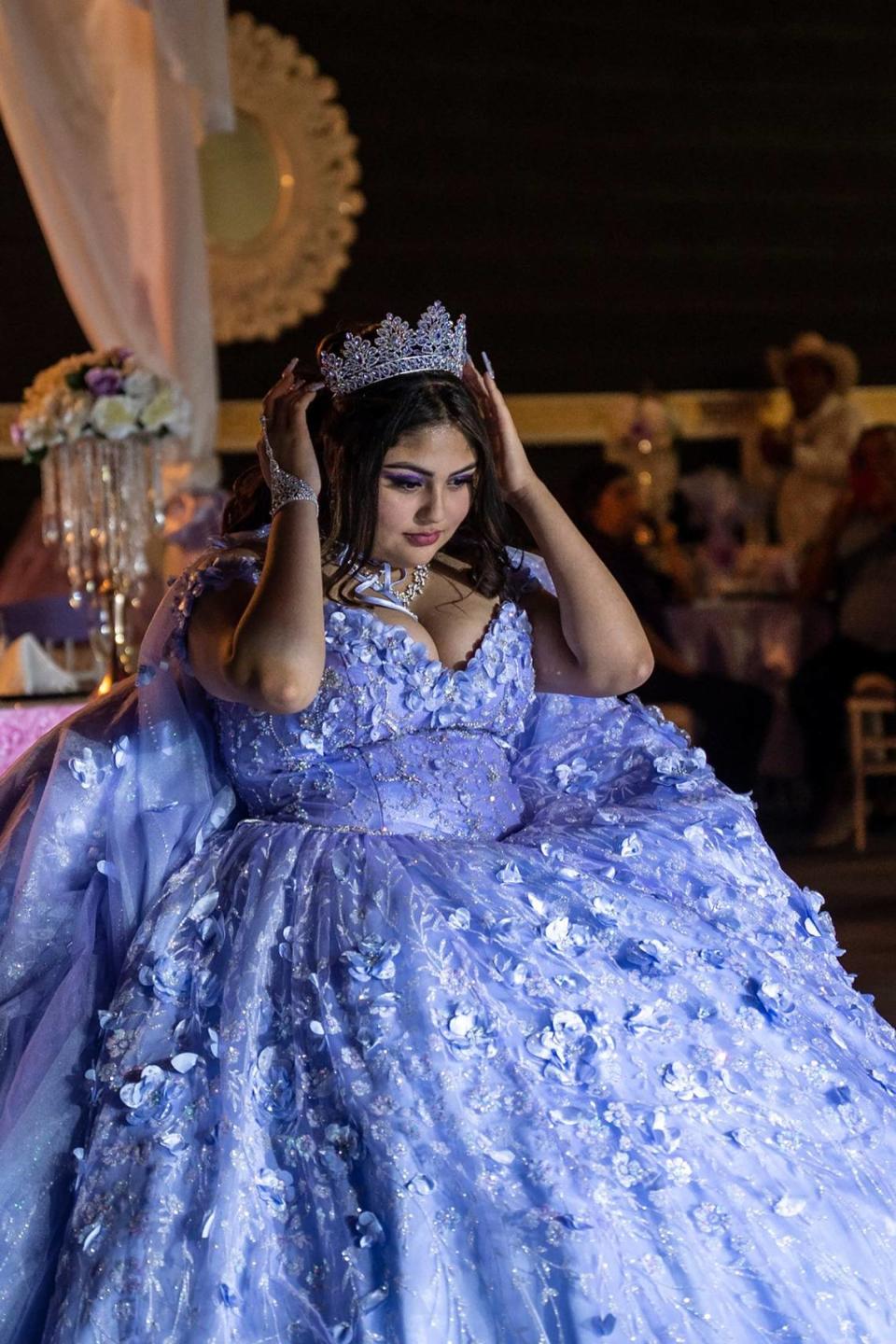 Daniela Robledo adjusts her crown at her quinceañera on Central Ave. in Charlotte.