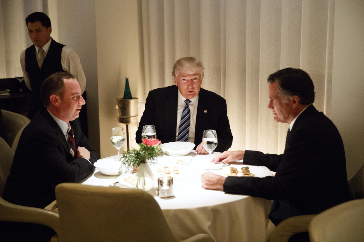 Donald Trump, center, with Mitt Romney, right, and Reince Priebus 