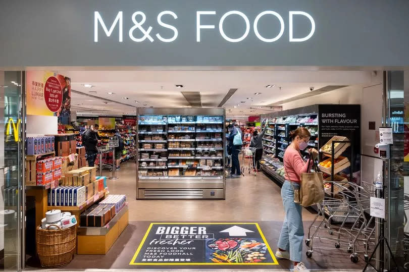 A customer is seen at the British multinational retailer Marks & Spencer