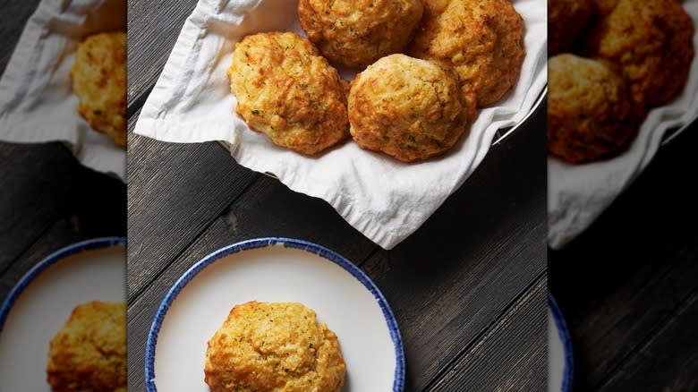 Biscuits in basket next to biscuit on plate