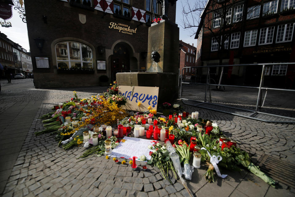 <p>Candles and flowers are placed at the site where, on April 7, a man drove a van into a group of people sitting outside a popular restaurant in the old city centre of Muenster, Germany April 8, 2018. Placard reads “Why?”. (Photo: Leon Kuegeler/Reuters) </p>