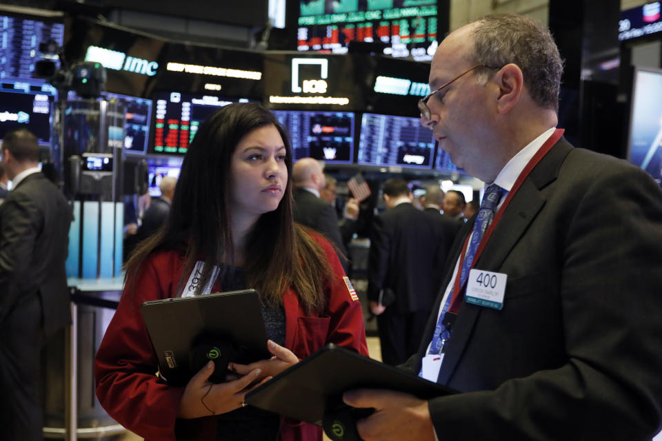 Traders Ashley Lara and Gordon Charlop work on the floor of the New York Stock Exchange, Tuesday, Nov. 12, 2019. Stocks are opening slightly higher on Wall Street, led by gains in technology and health care companies. (AP Photo/Richard Drew)