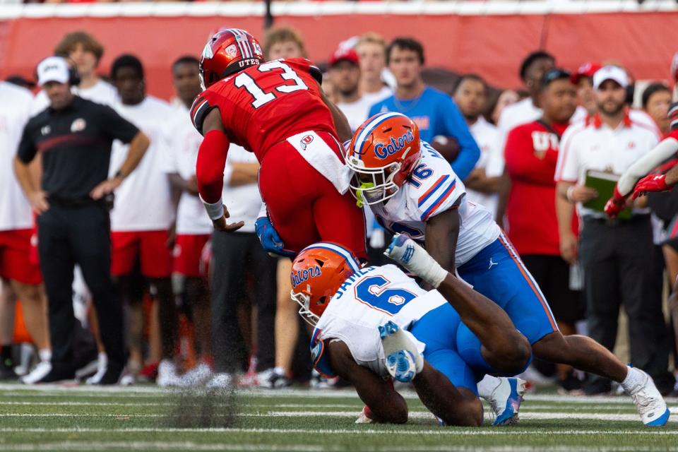 Florida Gators linebacker Shemar James (6) and Florida Gators safety R.J. Moten (16) bring down Utah Utes quarterback Nate Johnson (13) during the season opener at Rice-Eccles Stadium in Salt Lake City on Thursday, Aug. 31, 2023. | Megan Nielsen, Deseret News