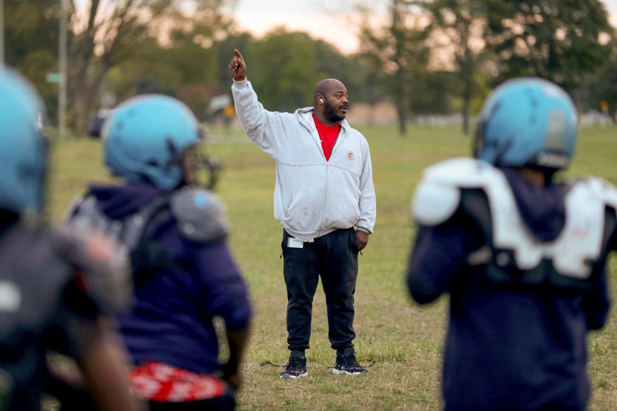 Timothy Rives Jr., a Detroit police shooting survivor, coaches his son, "Little Tim," in practice for the Detroit Police Athletic League team, the Jaguars, on Thursday, Oct. 12, 2023.