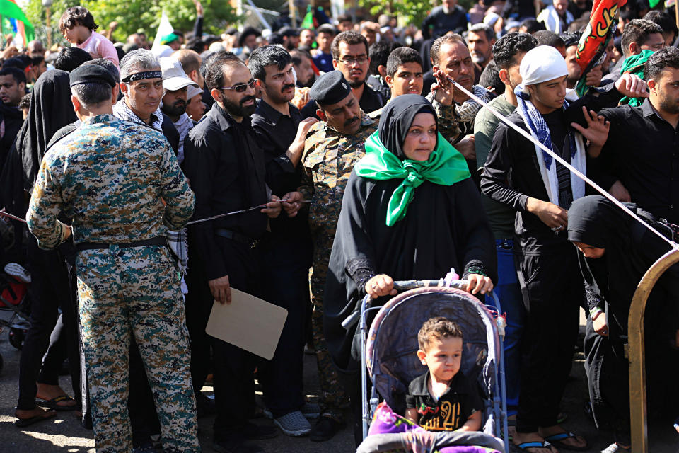 In this Tuesday, Oct. 30, 2018, photo Iraqi Security forces guard the Shiite faithful pilgrims while performing their rituals in Karbala, Iraq. Synagogues, mosques, churches and other houses of worship are routinely at risk of attack in many parts of the world. And so worshippers themselves often feel the need for visible, tangible protection even as they seek the divine. (AP Photo/Hadi Mizban)