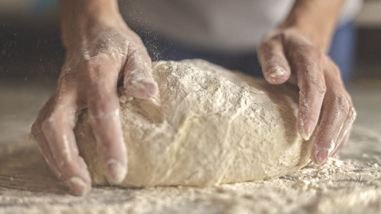 kneading homemade pizza dough
