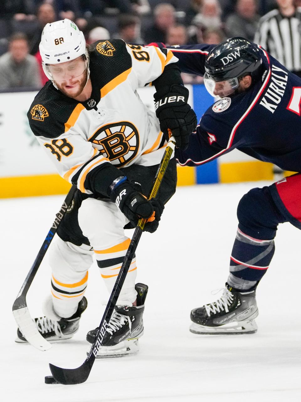 Mon., Apr. 4, 2022; Columbus, Ohio, USA; Columbus Blue Jackets center Sean Kuraly (7) defends as Boston Bruins right wing David Pastrnak (88) moves the puck during the second period of a NHL game between the Columbus Blue Jackets and the Boston Bruins at Nationwide Arena. Mandatory Credit: Joshua A. Bickel/Columbus Dispatch