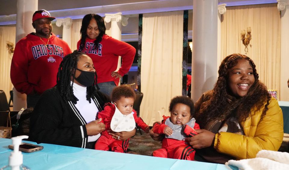 Wilhelmina Barnett, right, smiles as she talks with family, friends and media with her reunited twins, Kyair Thomas, left, and Kason Thomas on Dec. 31, 2022, during a private "Welcome Home" celebration Barnett and the babies' father, Lachez Thomas, held at an Columbus East Side party center. The twins were the focus of a multistate search after they went missing when Barnett's car was stolen Dec. 19, 2022, while she was picking up a DoorDash delivery order in Columbus. Holding Kyair in the photo is Mecka Curry, who was one of two Indianapolis women who found him inside Barnett's stolen car in the parking lot of a downtown Indianapolis pizza shop and led authorities to the suspect. Behind Curry is Dana and Erika Brock, who were two of hundreds of searchers in the Columbus area who helped search for the babies.