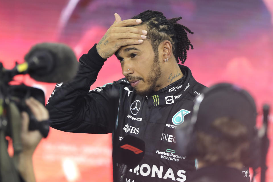 Mercedes driver Lewis Hamilton of Britain reacts after finishing second in the Formula One Abu Dhabi Grand Prix in Abu Dhabi, United Arab Emirates, Sunday, Dec. 12. 2021. Max Verstappen ripped a record eighth title away from Lewis Hamilton with a pass on the final lap of the Abu Dhabi GP to close one of the most thrilling Formula One seasons in years as the first Dutch world champion. (AP Photo/Kamran Jebreili, Pool)