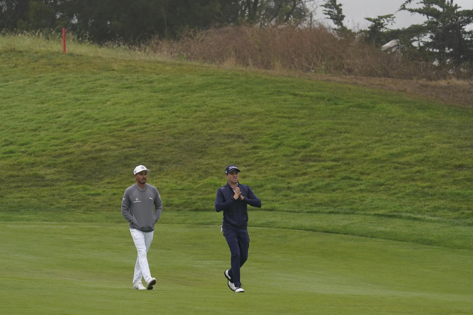 Rickie Fowler, left, and Justin Thomas walk on the 14th fairway during practice for the PGA Championship golf tournament at TPC Harding Park in San Francisco, Tuesday, Aug. 4, 2020. (AP Photo/Jeff Chiu)