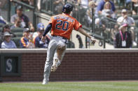 Houston Astros Chas McCormick points to home plate after scoring on a single by Houston Astros' Aledmys Diaz during the fourth inning of a baseball game against the Seattle Mariners, Wednesday, July 28, 2021, in Seattle. (AP Photo/Jason Redmond)