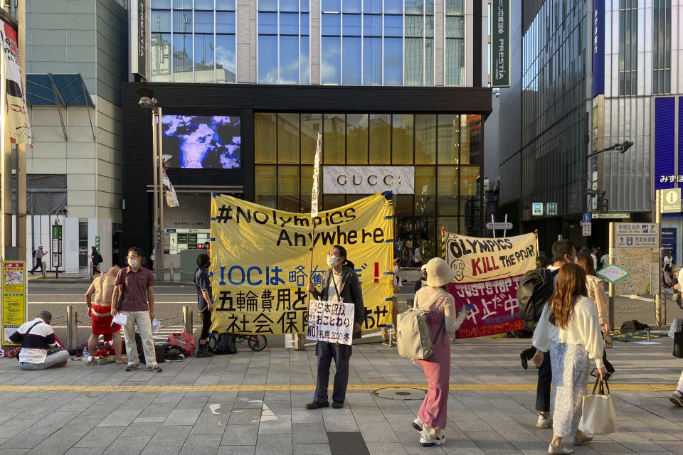 Protesters stage a rally against Japan's Sapporo 2030 Olympics bid, in Shinjuku district of Tokyo, Japan, Sunday, June 12, 2022. Holding “No Olympics” banners, protesters demanded Japan drop its bid for the 2030 Winter Games Sunday.(AP Photo/Yuri Kageyama)