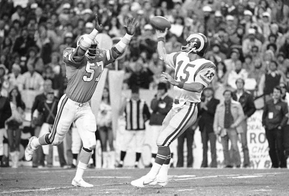 FILE - In this Sunday, Jan. 6, 1980, file photo, Tampa Bay Buccaneers' David Lewis, left, pressures Los Angeles Rams quarterback Vince Ferragamo during the NFC championship NFL football game in Tampa. Lewis, a key member of the Buccaneers’ historic 1979 team that reached the NFC title game, has died. He was 65. Lewis died Tuesday, July 14, 2020, in Tampa. The cause was not immediately known, but he had struggled with health issues in recent years. (AP Photo/File)