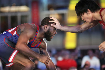 U.S. wrestler Jordan Burroughs (L) spars with Japanese wrestler Sohsuke Takatani at the "Beat The Streets" wrestling event in Times Square, New York City, U.S., May 17, 2017. REUTERS/Joe Penney