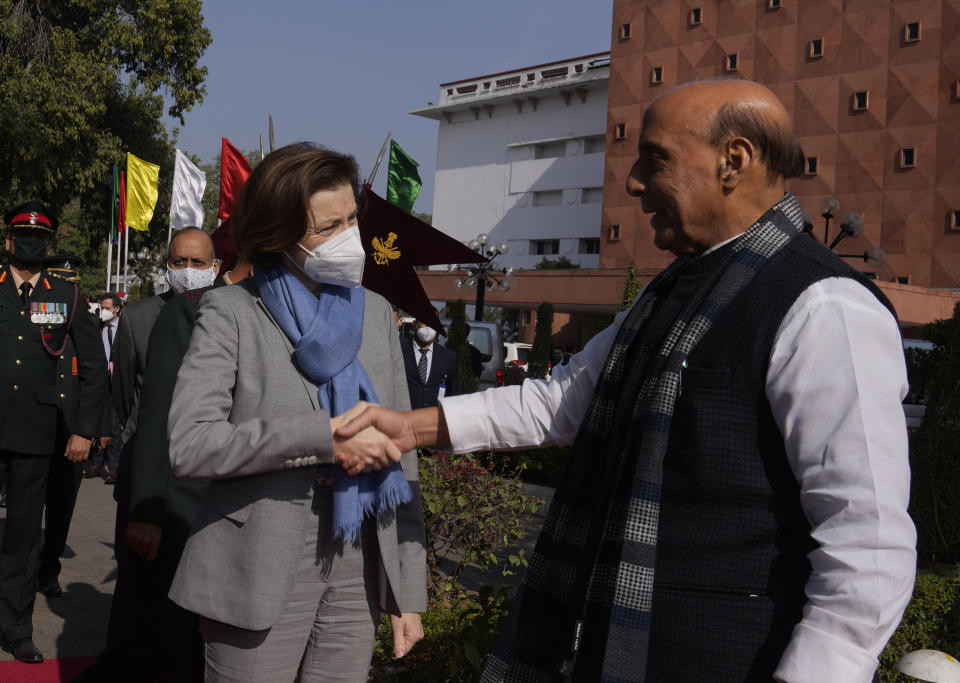 India's defense minister Rajnath Singh, right, shakes hands with his French counterpart Florence Parly upon her arrival for a joint military guard of honour in New Delhi, India, Friday, Dec. 17, 2021. (AP Photo/Manish Swarup)