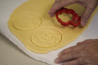 Julie Muller, who sells cookie decorating kits on Etsy, makes cutout cookies with the likeness of President Obama Tuesday, Sept. 22, 2020, in Houston. One of the cookie-decorating kits she offers has a Black Lives Matter theme. Amid all the Black Lives Matter themed T-shirts, face masks and signs appearing in recent months, some unconventional merchandise has been popping up on online crafts marketplace Etsy. (AP Photo/David J. Phillip)