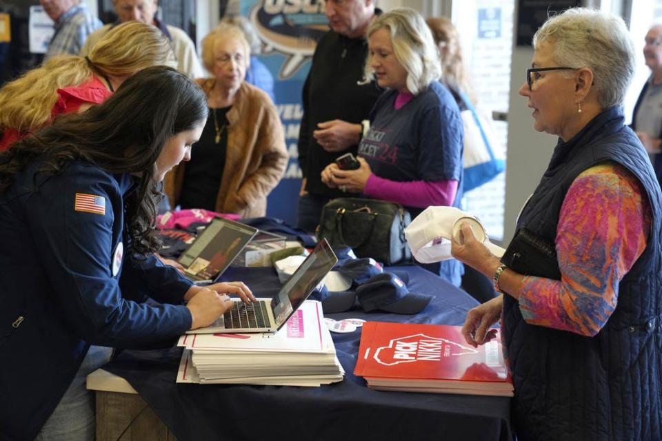 Supporters buy merchandise ahead of a campaign event for GOP presidential hopeful Nikki Haley on Monday, Nov. 27, 2023, in Bluffton, S.C. Haley is among a cluster of Republican candidates competing for second place in a GOP Republican primary thus far largely dominated by former President Donald Trump. (AP Photo/Meg Kinnard) ORG XMIT: SCMK101