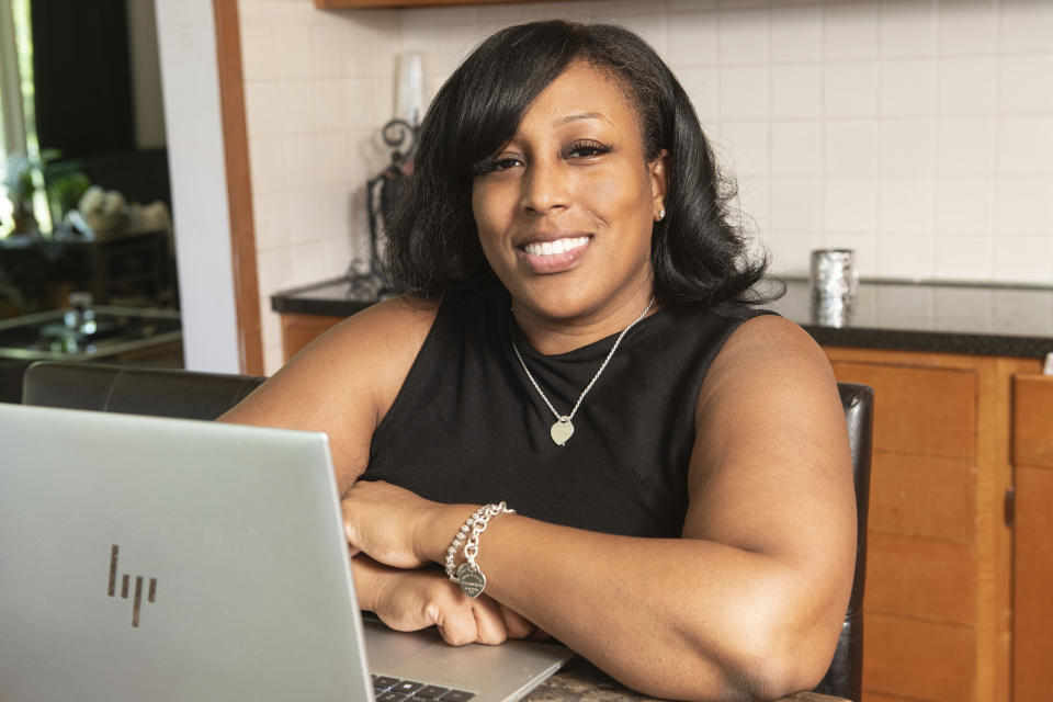 Raquel Robinson poses at her home in Cleveland Heights, Ohio, Wednesday, June 12, 2024. After her daughter was born in October 2022, Robinson was diagnosed with postpartum depression. (AP Photo/Phil Long)