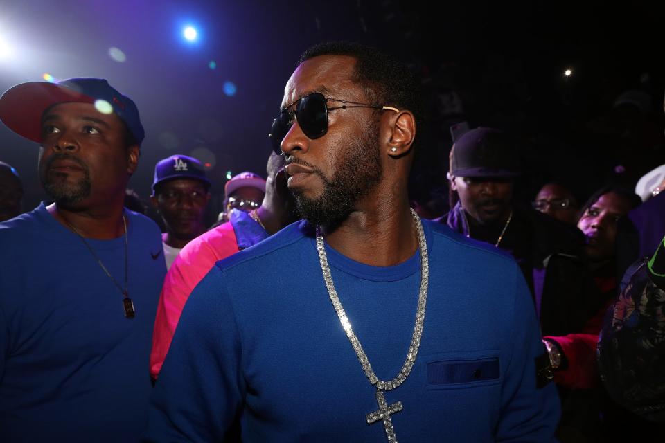 Sean Combs in a blue shirt and big silver chain