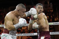 Isaac Cruz, of Mexico, hits Rolando Romero in a super lightweight title bout Saturday, March 30, 2024, in Las Vegas. (AP Photo/John Locher)