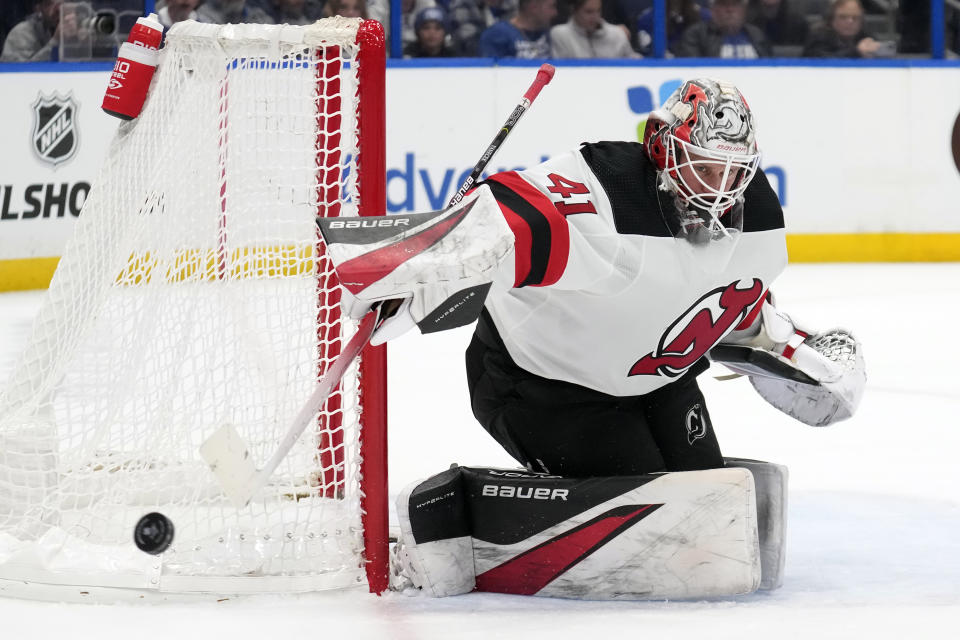 New Jersey Devils goaltender Vitek Vanecek (41) makes a stick save on a shot by the Tampa Bay Lightning during the second period of an NHL hockey game Thursday, Jan. 11, 2024, in Tampa, Fla. (AP Photo/Chris O'Meara)