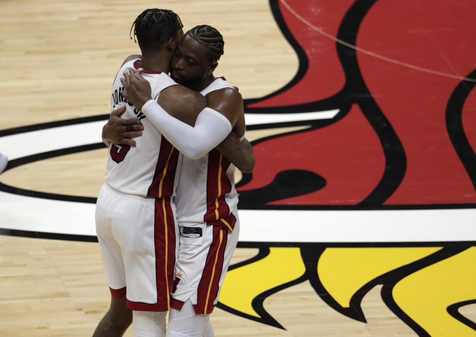 Miami Heat guard Dwyane Wade hugs Derrick Jones Jr. after playing his final home regular season basketball game, in a game against the Philadelphia 76ers, Tuesday, April 9, 2019, in Miami. Wade is retiring at the end of the season. (AP Photo/Lynne Sladky)