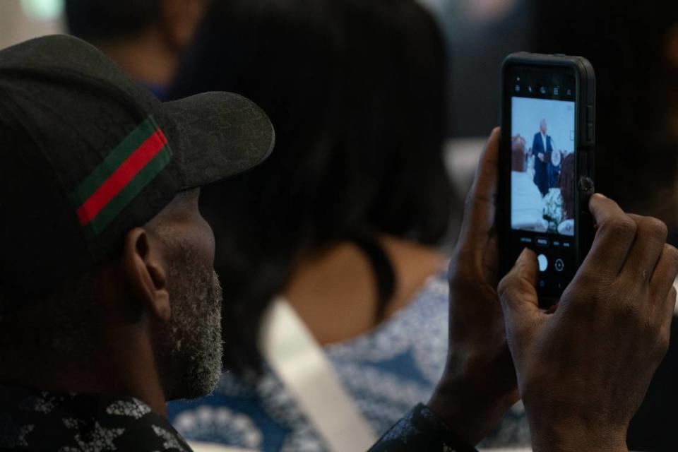 A man records comments by state officials Friday in Venice, where Gov. J.B. Pfitzker signed a bill granting roughly $20 million to combat food deserts in rural, urban and suburban communities.