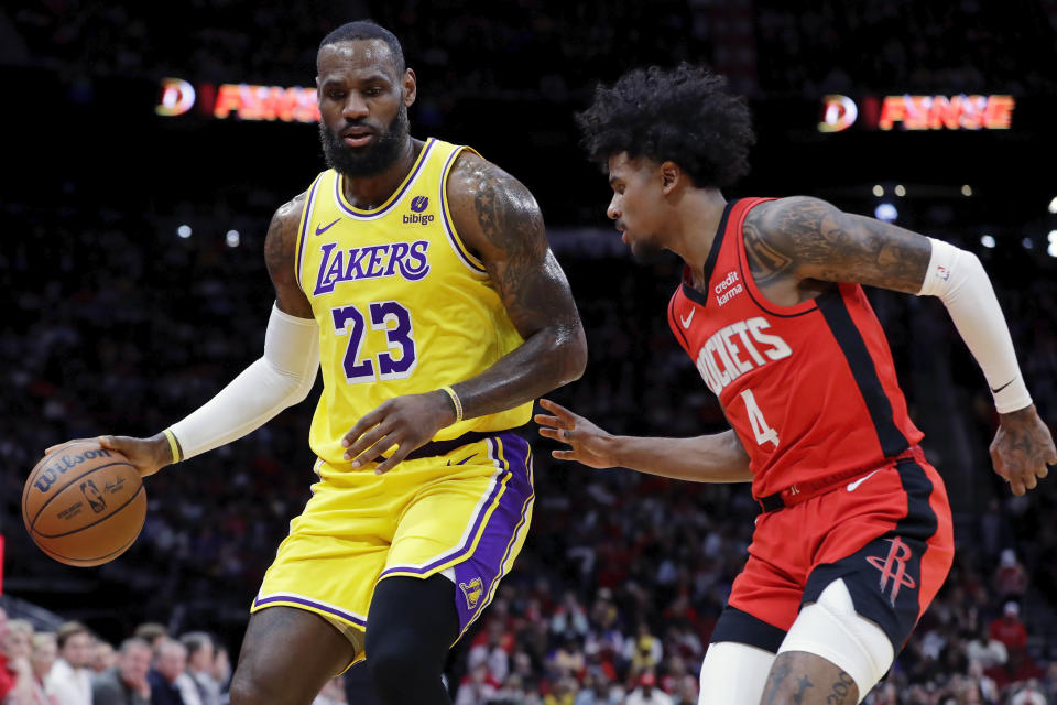 Los Angeles Lakers forward LeBron James (23) attempts to drive around Houston Rockets guard Jalen Green (4) during the first half of an NBA basketball game Monday, Jan. 29, 2024, in Houston. (AP Photo/Michael Wyke)