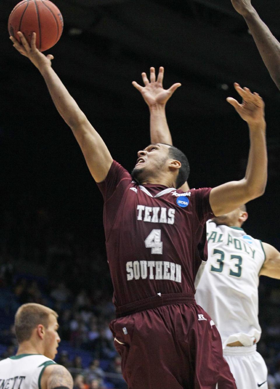 Texas Southern forward Jose Rodriguez (4) drives past Cal Poly forward Chris Eversley (33) in the first half of a first-round game of the NCAA college basketball tournament on Wednesday, March 19, 2014, in Dayton, Ohio. (AP Photo/Skip Peterson)