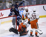 Winnipeg Jets' Morgan Barron (36) celebrate his goal on Anaheim Ducks goaltender Anthony Stolarz (41) during the third period of an NHL Hockey game in Winnipeg, Manitoba on Sunday, Dec. 4, 2022. (Fred Greenslade/The Canadian Press via AP)