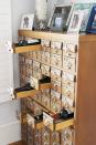 <p>A bottle of wine fits perfectly into a drawer of an old card catalog. Drawers without wine offer a perfect spot to stash birthday and other holiday cards.</p>