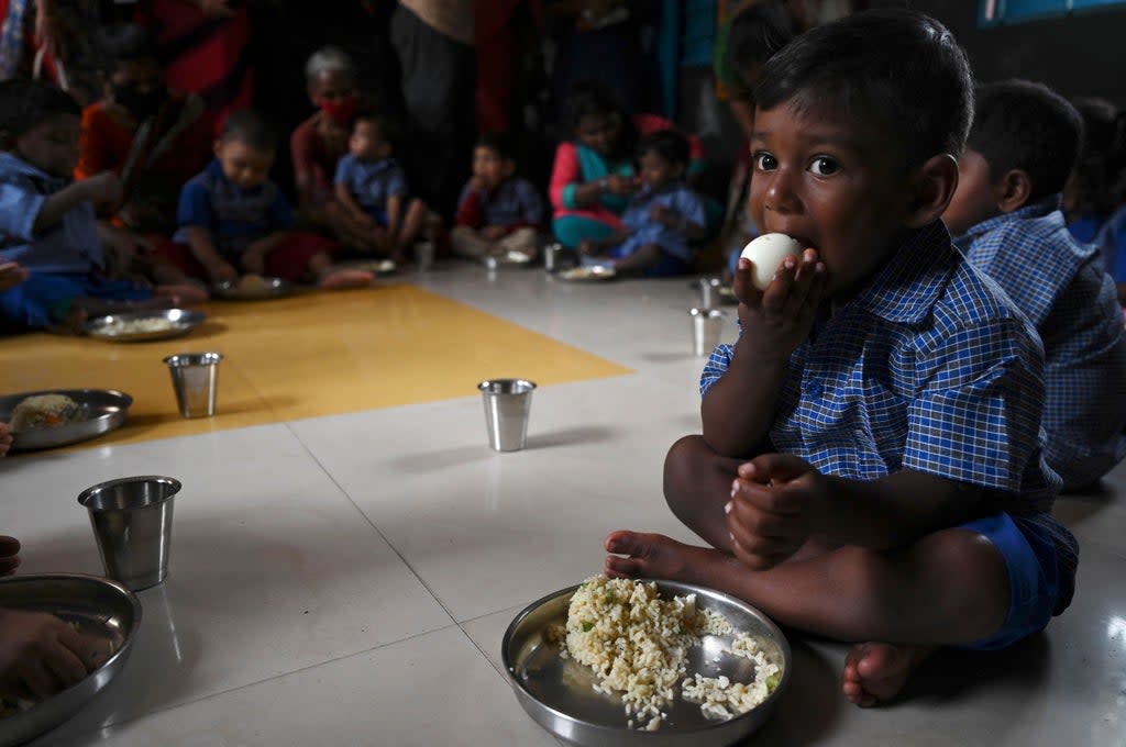 Children eat a meal at a pre-school in Chennai on 1 September  2021, after the state government relaxed the Covid-19 coronavirus lockdown norms for educational institutions, allowing students to attend physical classes (AFP via Getty Images)