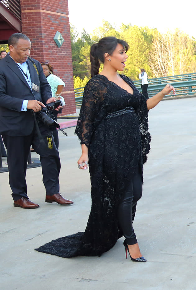 Kim Kardashian attended a film premiere with her baby bump on full display in this black dress and leggings combination. Copyright [Splash]