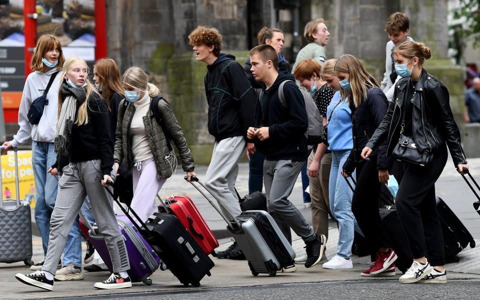 Young members of the public walk down Princess Street in Edinburgh as a new law comes into force limiting social gatherings to a maximum of six people from two households -  Getty Images Europe