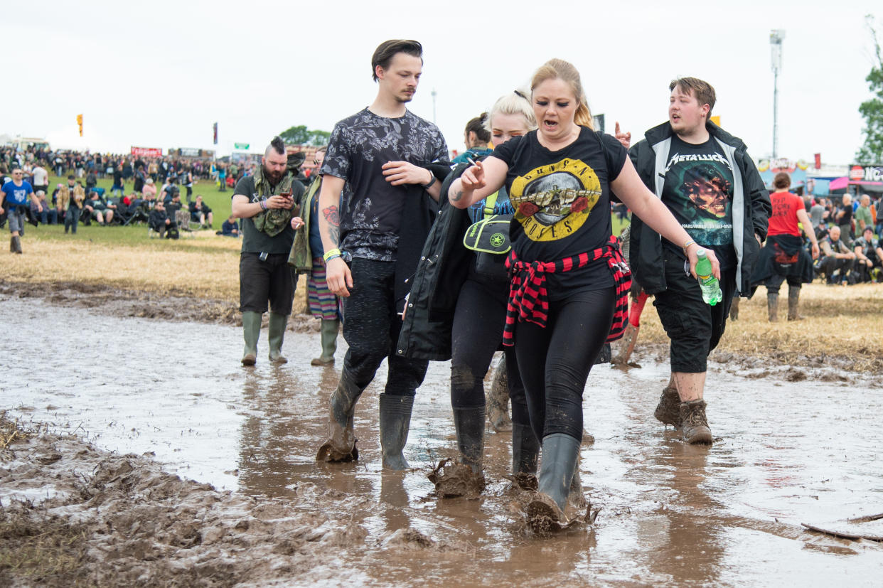 CASTLE DONINGTON, ENGLAND - JUNE 14:  Festival goers brave the muddy fields during day 1 at Download festival 2019 at Donington Park on June 14, 2019 in Castle Donington, England.  (Photo by Joseph Okpako/WireImage)