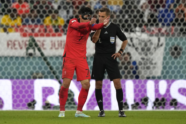 South Korea's Son Heung-min, left, speaks to the referee Clement Turpin during the World Cup group H soccer match between Uruguay and South Korea, at the Education City Stadium in Al Rayyan , Qatar, Thursday, Nov. 24, 2022. (AP Photo/Frank Augstein)