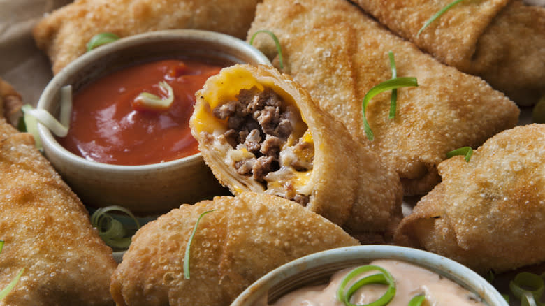 Plate of meatball egg rolls with dipping sauces