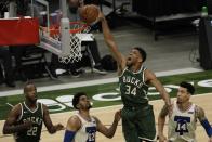 Milwaukee Bucks' Giannis Antetokounmpo dunks during the second half of an NBA basketball game against the Philadelphia 76ers Saturday, April 24, 2021, in Milwaukee. (AP Photo/Morry Gash)