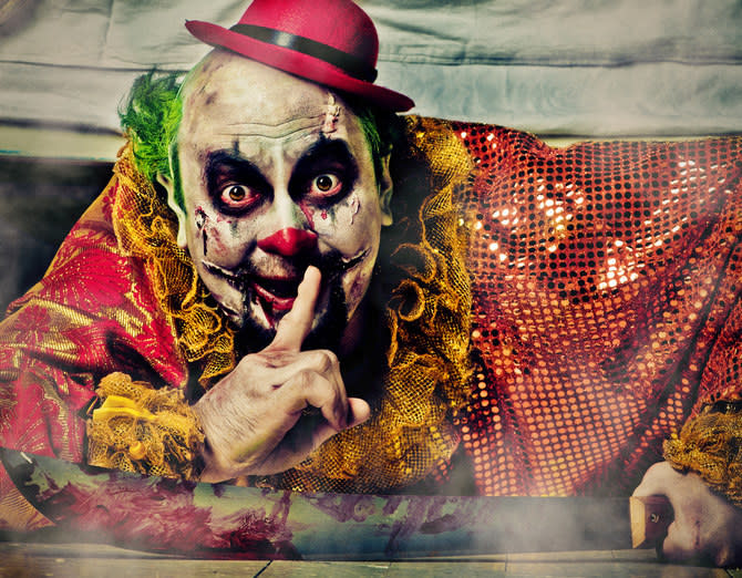 A scary clown gesturing "Shhh"