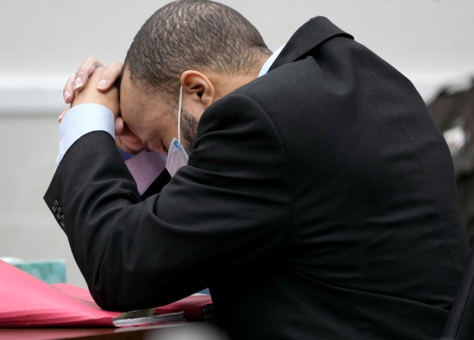 Darrell Brooks puts his head in his hands as the verdict is read out (AP)