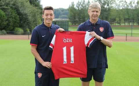  Arsenal manager Arsene Wenger with new signing Mesut Oezil at London Colney  - Credit: Getty Images