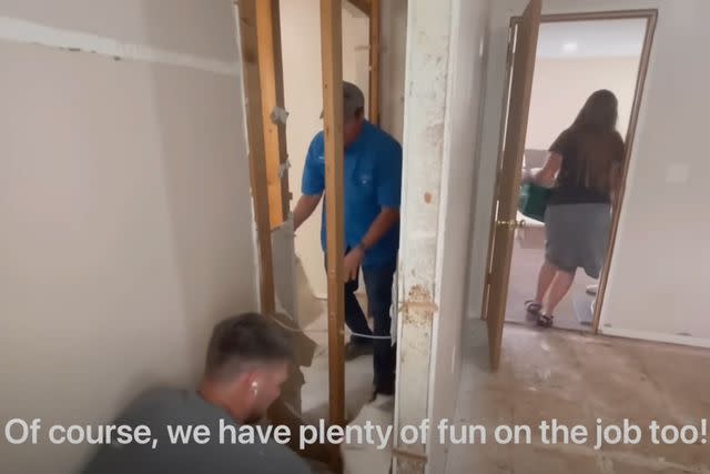 <p>Jana Duggar/YouTube</p> Stephen Wissmann and Jim Bob Duggar pulling apart one of the walls