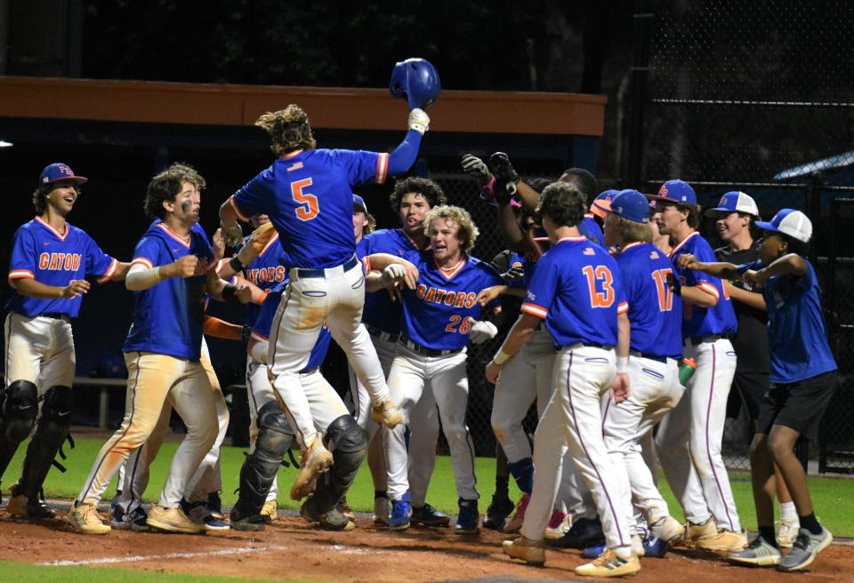 Palm Beach Gardens players celebrate Luke Hogue's walk-off home-run in the bottom of the eighth inning against Park Vista on Mar. 12, 2024.