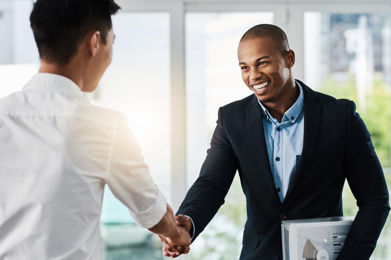 African American man shaking hand with Asian man at job interview