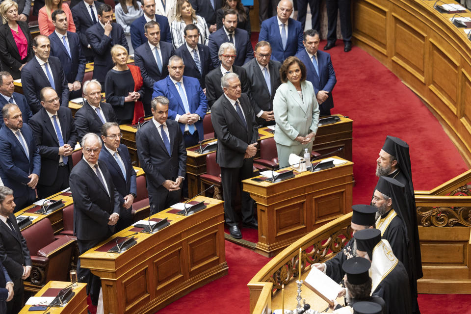 Greece's former Prime Minister and leader of New Democracy party Kyriakos Mitsotakis, third right front row, attends a swearing in ceremony at the parliament in Athens, Greece, Sunday, May 28, 2023. Newly elected Greek lawmakers were sworn in Sunday, but the Parliament elected on May 21 could be dissolved as early as Monday and a new election campaign start for another election, on June 25. (AP Photo/Yorgos Karahalis)