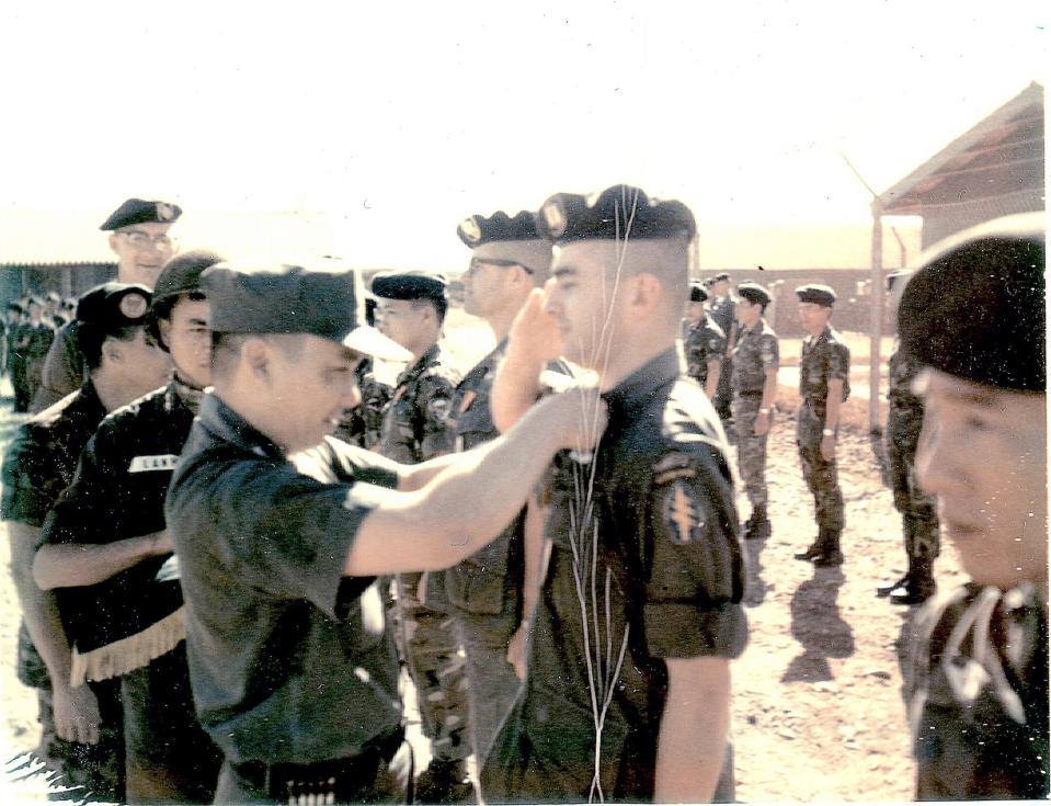 Lennon receives the Vietnamese Gallantry Cross from Col. Lam Phong, deputy commander of Vietnamese Special Forces, in March 1968.