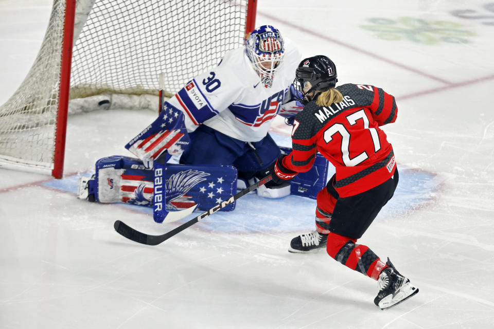 Canada forward Emma Maltais (27) scores a goal against United States goaltender Abbey Levy (30) in the third period of a women's Rivalry Series hockey game Sunday, Feb. 11, 2024, in St. Paul, Minn. (AP Photo/Bruce Kluckhohn)