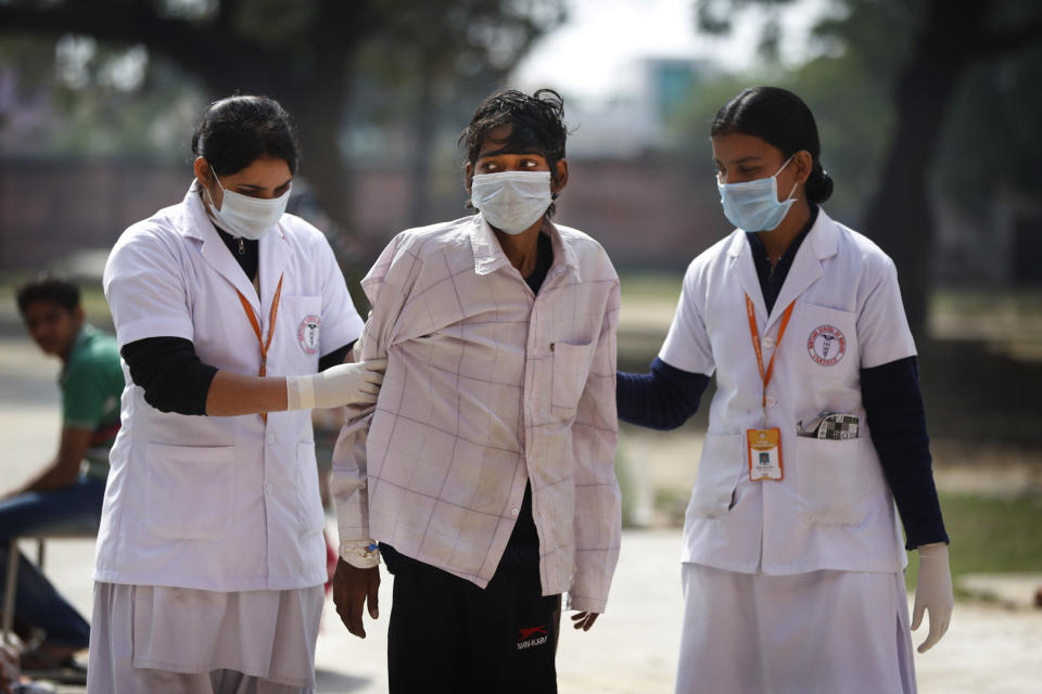 In this Monday, Feb. 3, 2014 photo, Indian nurses help a tuberculosis patient Manjeet Mishra, 18, center, walk towards his ward at Lal Bahadur Shastri Government Hospital at Ram Nagar in Varanasi, India. India has the highest incidence of TB in the world, according to the World Health Organization's Global Tuberculosis Report 2013, with as many as 2.4 million cases. India saw the greatest increase in multidrug-resistant TB between 2011 and 2012. The disease kills about 300,000 people every year in the country. (AP Photo/Rajesh Kumar Singh)