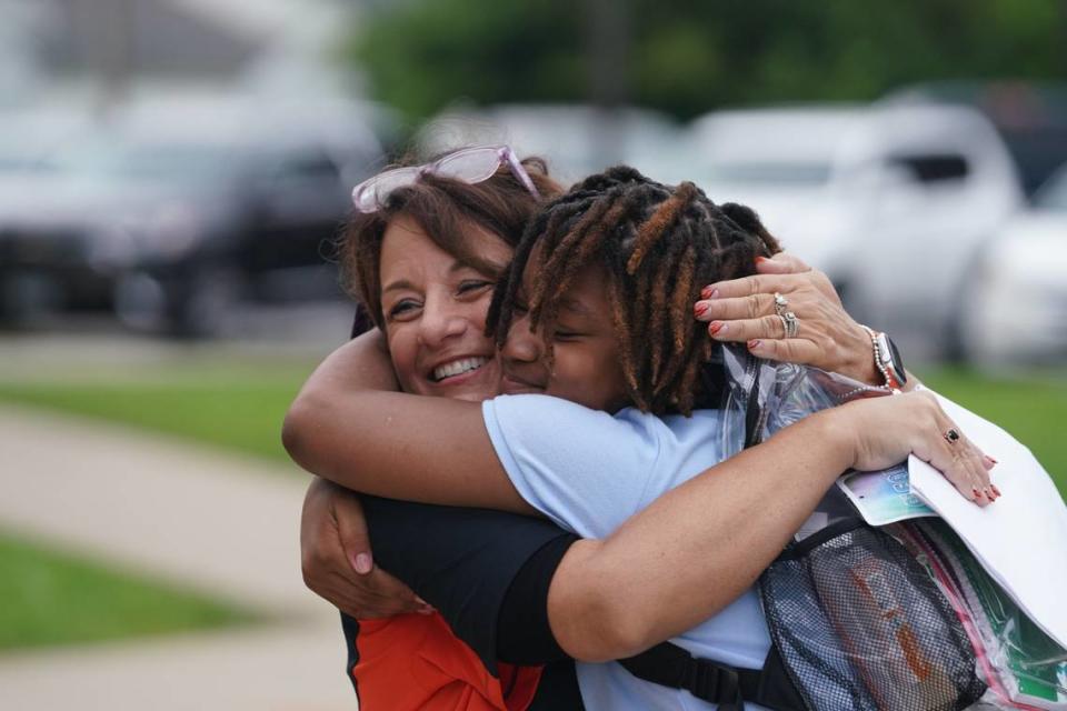 Officer Elementary principal Darla Wall hugs a student as the school year opens on Aug. 14, 2023. Lincoln Middle School and Officer Elementary opened on the same day, each filled with staff and community partners cheering on students as they entered the building.